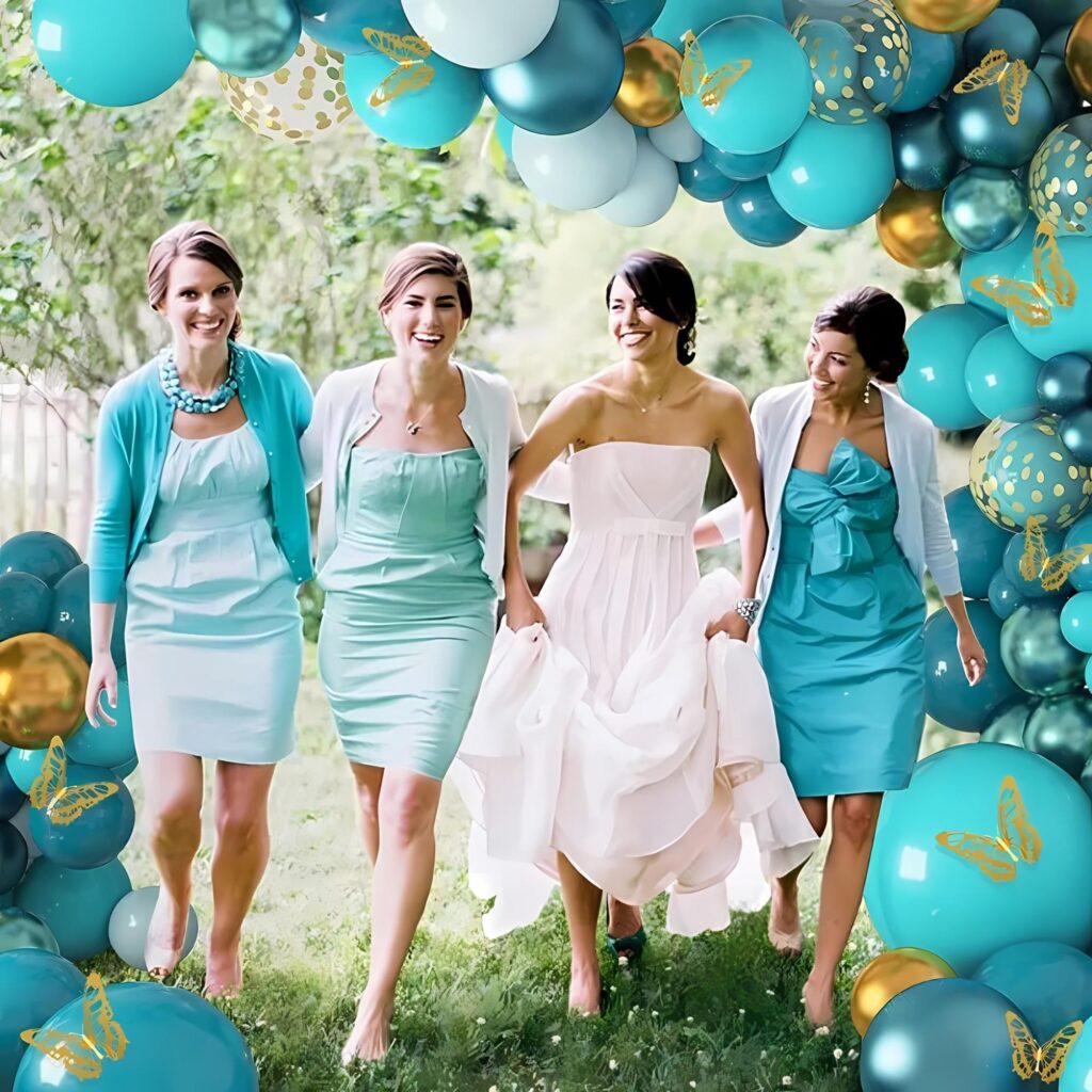 teal balloon arch kit as a backdrop for a bridal party